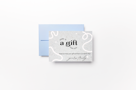 Gift card with a light blue envelope and a minimalistic design featuring a white background with soft abstract lines. The card reads 'Here is a gift for you' with a message below saying 'Hope you enjoy your gift and have a wonderful day!' followed by a cursive 'yours truly' signature